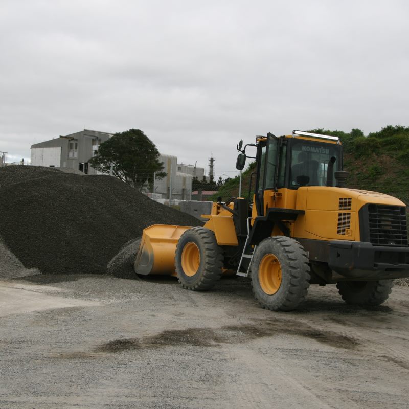 digger moving gravel for concrete